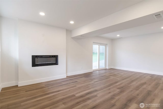 2015 172nd Pl SE, Bothell, WA 98012 - unfurnished living room featuring wood finished floors, baseboards, recessed lighting, and a glass covered fireplace