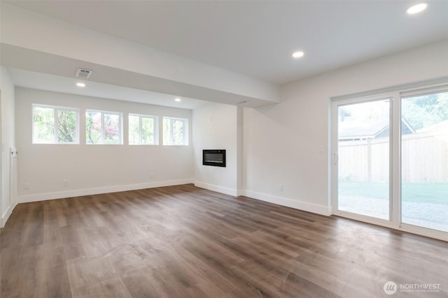 2015 172nd Pl SE, Bothell, WA 98012 - unfurnished living room featuring baseboards, dark wood-style flooring, recessed lighting, and a glass covered fireplace