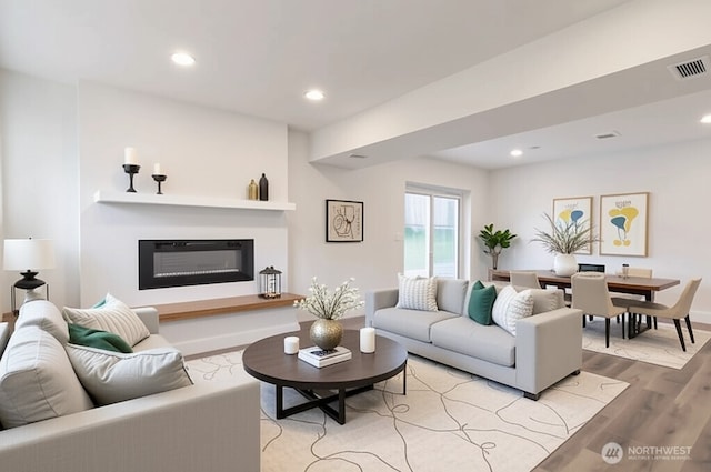 2015 172nd Pl SE, Bothell, WA 98012 - living room featuring light wood-style flooring, a glass covered fireplace, recessed lighting, and baseboards