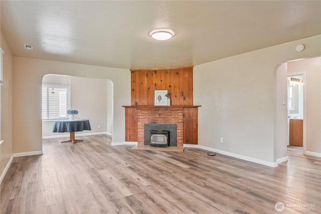 2938 Field St, Longview, WA 98632 - unfurnished living room featuring arched walkways, light wood-style floors, and baseboards