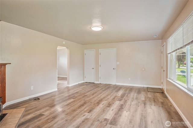 2938 Field St, Longview, WA 98632 - unfurnished room with arched walkways, light wood finished floors, and baseboards