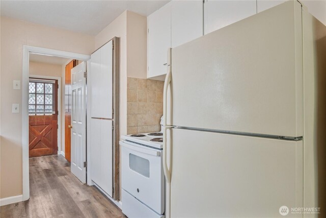 2938 Field St, Longview, WA 98632 - kitchen featuring white appliances, white cabinets, and light wood-style flooring
