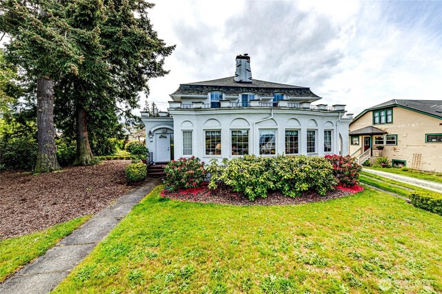 1324 E 2nd St, Port Angeles, WA 98362 - back of house with a lawn, a chimney, and stucco siding
