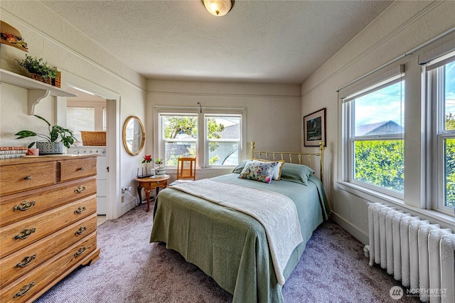 1324 E 2nd St, Port Angeles, WA 98362 - bedroom with radiator, multiple windows, light colored carpet, and a textured ceiling