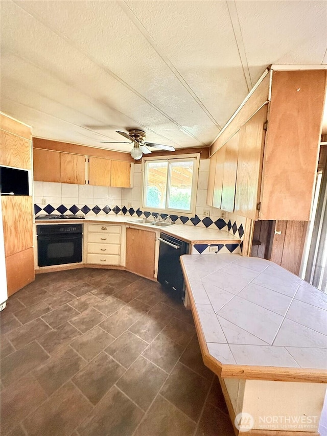 1485B Old Hwy 97, Malott, WA 98840 - kitchen featuring black appliances, tile countertops, tasteful backsplash, ceiling fan, and a textured ceiling