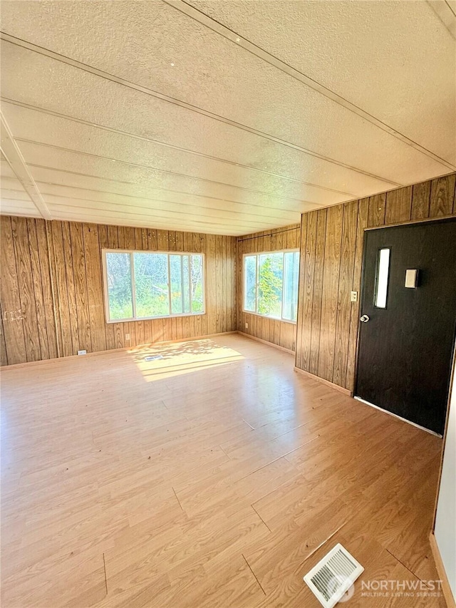 1485B Old Hwy 97, Malott, WA 98840 - empty room with wood finished floors, a textured ceiling, and wooden walls