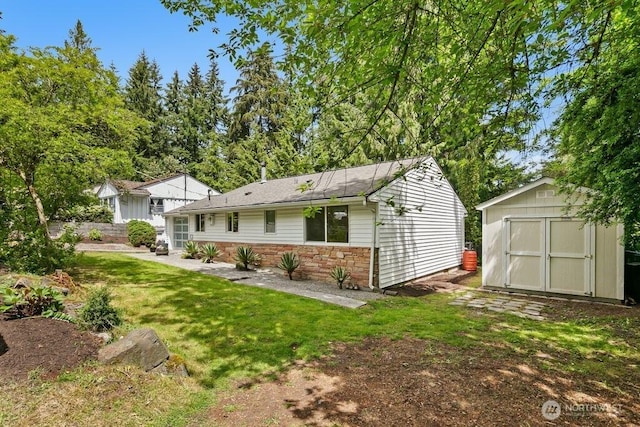 1256 NE 188th St, Shoreline, WA 98155 - rear view of property with a yard and stone siding