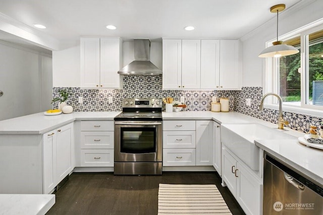 1256 NE 188th St, Shoreline, WA 98155 - kitchen featuring appliances with stainless steel finishes, wall chimney range hood, a sink, a peninsula, and white cabinets