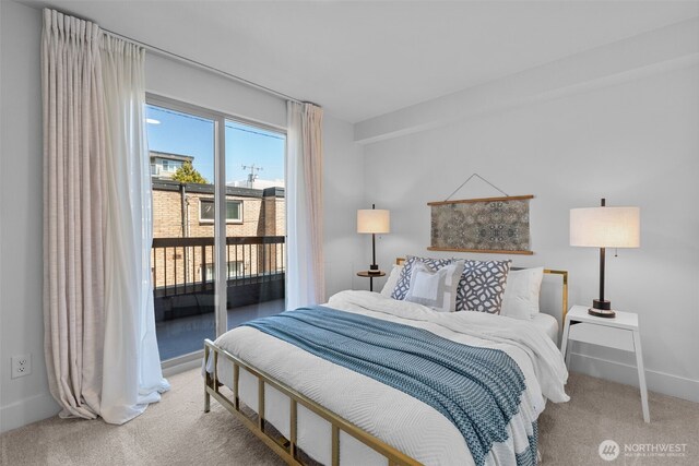 500 5th Ave W Unit 501, Seattle, WA 98119 - carpeted bedroom featuring access to outside and baseboards