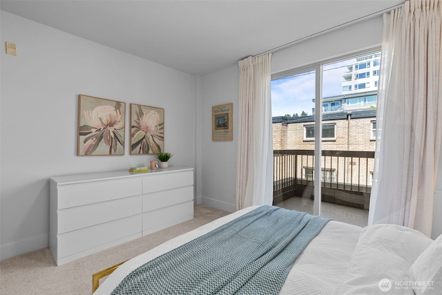 500 5th Ave W Unit 501, Seattle, WA 98119 - bedroom with access to exterior, light carpet, and baseboards