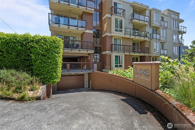 500 5th Ave W Unit 501, Seattle, WA 98119 - view of apartment building / complex featuring an attached garage and driveway