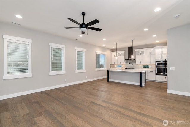7547 S 130th Pl, Seattle, WA 98178 - kitchen with recessed lighting, a ceiling fan, light countertops, white cabinets, and open floor plan