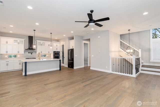 7547 S 130th Pl, Seattle, WA 98178 - kitchen featuring wall chimney exhaust hood, high quality fridge, double oven, light countertops, and recessed lighting