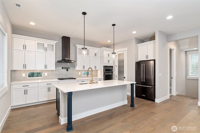 7547 S 130th Pl, Seattle, WA 98178 - kitchen featuring high end fridge, wall chimney range hood, a sink, double oven, and black gas cooktop