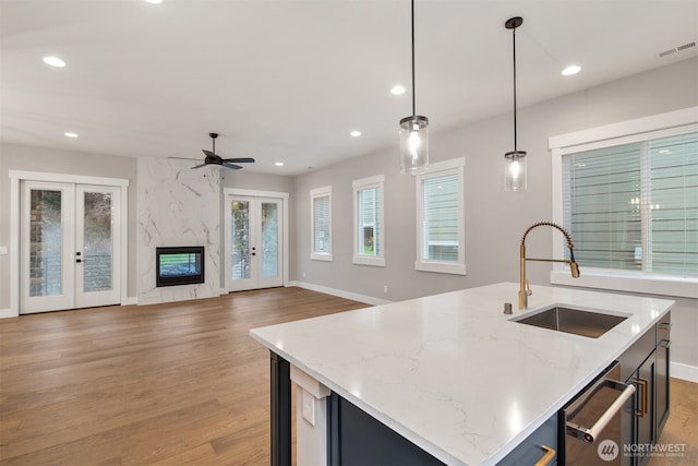 7547 S 130th Pl, Seattle, WA 98178 - kitchen with a sink, french doors, light wood-style flooring, dishwasher, and recessed lighting