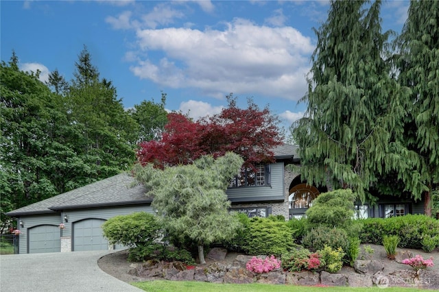 5920 228th Ave NE, Redmond, WA 98053 - obstructed view of property featuring a garage, a shingled roof, and driveway