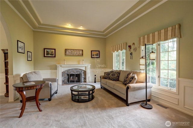 5920 228th Ave NE, Redmond, WA 98053 - carpeted living area with healthy amount of natural light, ornamental molding, a raised ceiling, arched walkways, and a wainscoted wall