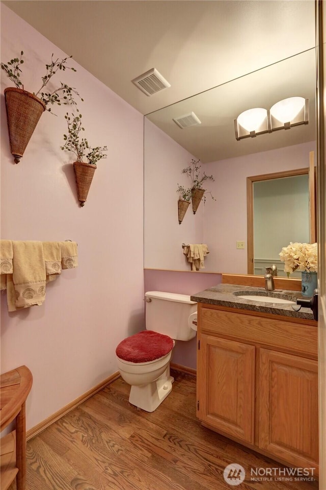 5920 228th Ave NE, Redmond, WA 98053 - half bathroom featuring toilet, wood finished floors, vanity, and baseboards