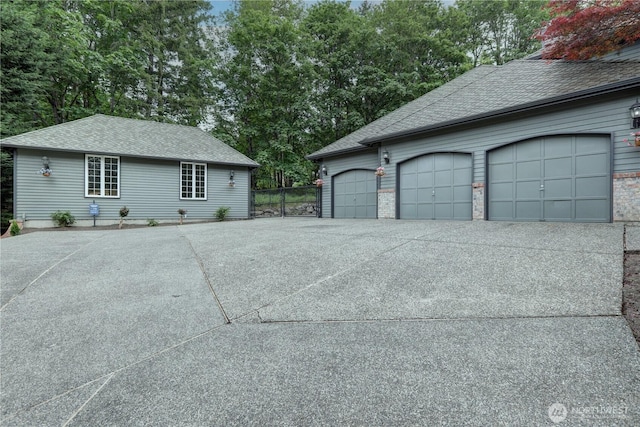 5920 228th Ave NE, Redmond, WA 98053 - view of property exterior featuring a garage, roof with shingles, and driveway