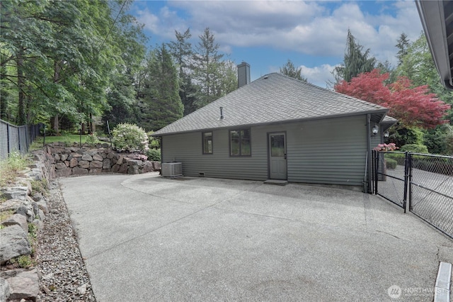 5920 228th Ave NE, Redmond, WA 98053 - back of property with a patio, a chimney, cooling unit, and roof with shingles