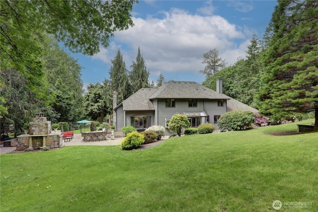 5920 228th Ave NE, Redmond, WA 98053 - rear view of house with a chimney, an outdoor fireplace, a patio, and a yard
