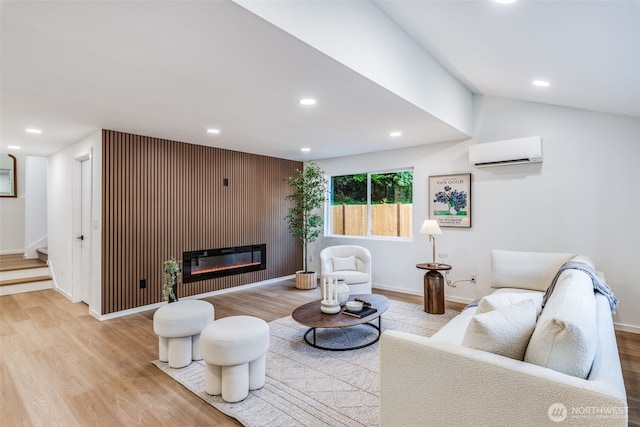3718 W Arsenal Way, Bremerton, WA 98312 - living area with a wall mounted AC, wood finished floors, recessed lighting, baseboards, and a glass covered fireplace