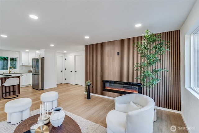 3718 W Arsenal Way, Bremerton, WA 98312 - living room with a glass covered fireplace, light wood-style floors, recessed lighting, baseboards, and an accent wall