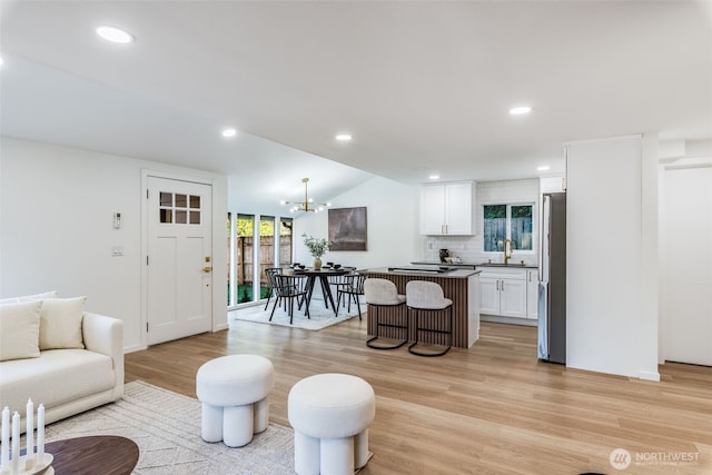 3718 W Arsenal Way, Bremerton, WA 98312 - living area with light wood-style floors, a chandelier, recessed lighting, and lofted ceiling