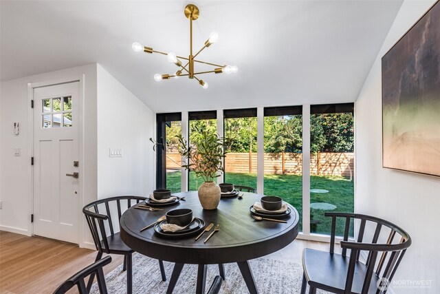 3718 W Arsenal Way, Bremerton, WA 98312 - dining area with a chandelier, lofted ceiling, and light wood-type flooring