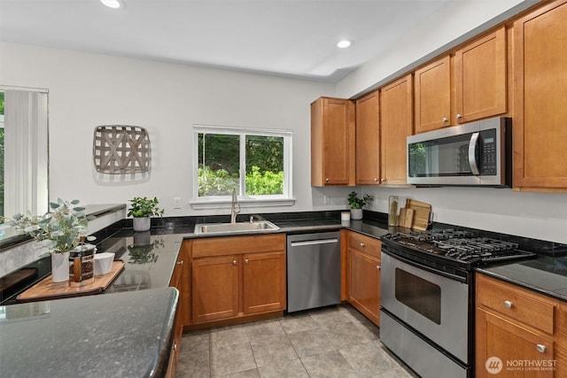 5529 Lakemont Blvd SE Unit 901, Bellevue, WA 98006 - kitchen featuring stainless steel appliances, a sink, recessed lighting, brown cabinetry, and dark stone counters