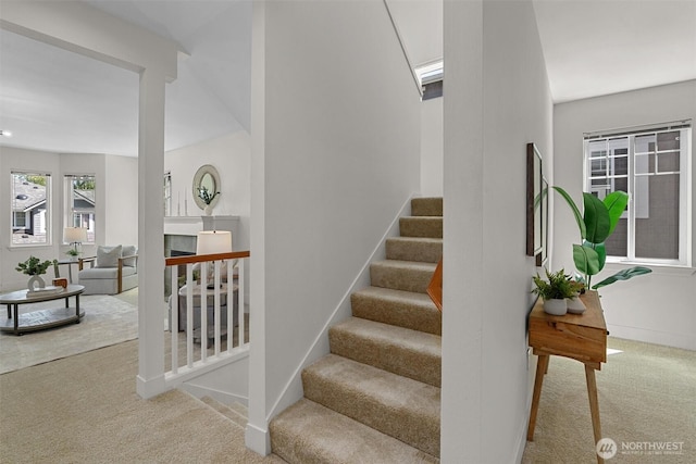 5529 Lakemont Blvd SE Unit 901, Bellevue, WA 98006 - stairway featuring carpet floors, a fireplace, and baseboards