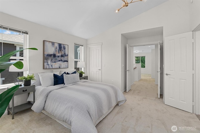 5529 Lakemont Blvd SE Unit 901, Bellevue, WA 98006 - bedroom featuring light colored carpet, lofted ceiling, multiple windows, and baseboards