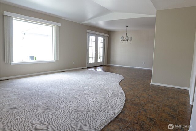 6 Laguna Pl W, Omak, WA 98841 - unfurnished room with a chandelier, baseboards, and vaulted ceiling