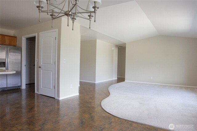 6 Laguna Pl W, Omak, WA 98841 - unfurnished living room featuring a chandelier, baseboards, and vaulted ceiling