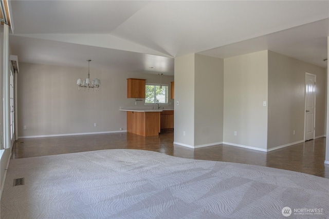 6 Laguna Pl W, Omak, WA 98841 - unfurnished bedroom featuring a chandelier, lofted ceiling, baseboards, and a sink