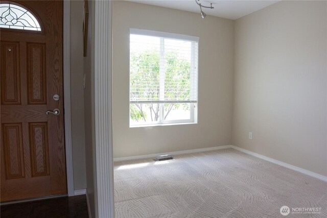 6 Laguna Pl W, Omak, WA 98841 - entrance foyer featuring baseboards, dark colored carpet, and plenty of natural light