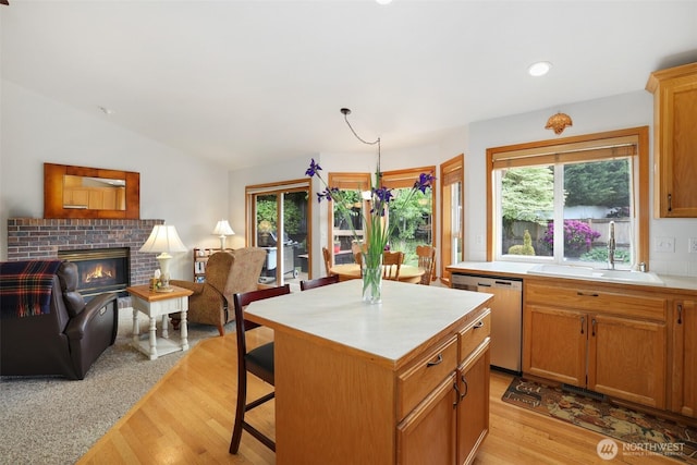 15427 148th Avenue Ct E, Orting, WA 98360 - kitchen with dishwasher, a sink, open floor plan, light countertops, and light wood-style flooring