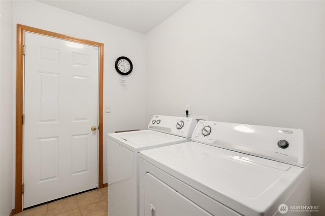 15427 148th Avenue Ct E, Orting, WA 98360 - laundry area with washing machine and clothes dryer and light tile patterned floors