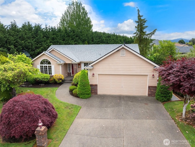 15427 148th Avenue Ct E, Orting, WA 98360 - view of front facade with brick siding, an attached garage, driveway, and roof with shingles