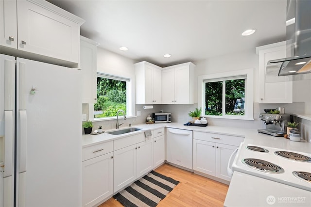 3755 Cyprus Way, Ferndale, WA 98248 - kitchen featuring a sink, white appliances, ventilation hood, tasteful backsplash, and light wood-style floors