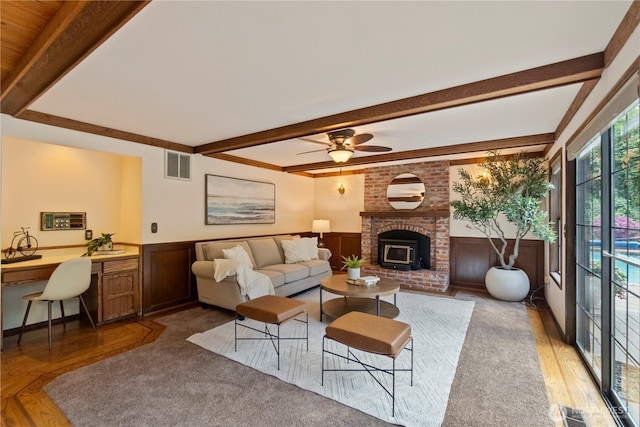 21102 31st Ave SE, Bothell, WA 98021 - living area with wood finished floors, beamed ceiling, wainscoting, and ceiling fan