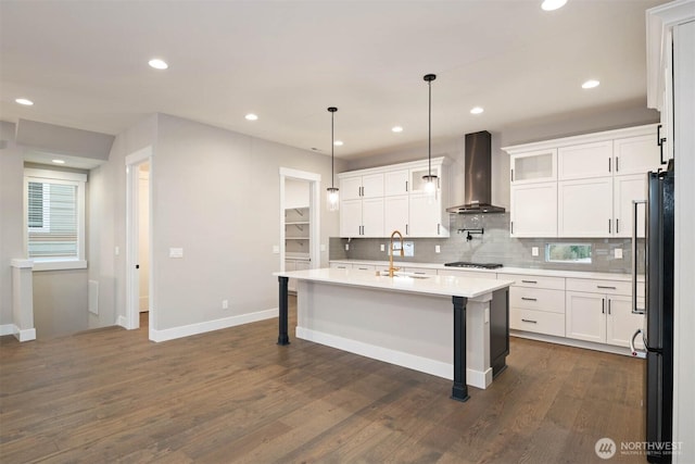 13037 75th Pl S, Seattle, WA 98178 - kitchen featuring wall chimney exhaust hood, freestanding refrigerator, light countertops, backsplash, and baseboards