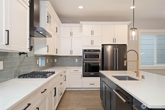 13037 75th Pl S, Seattle, WA 98178 - kitchen with wall chimney exhaust hood, appliances with stainless steel finishes, a sink, white cabinets, and recessed lighting