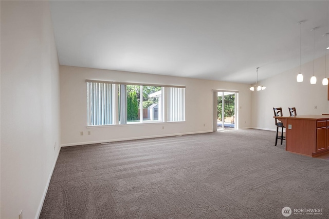 1210 24th St SE, Auburn, WA 98002 - unfurnished living room featuring carpet, a chandelier, baseboards, and vaulted ceiling