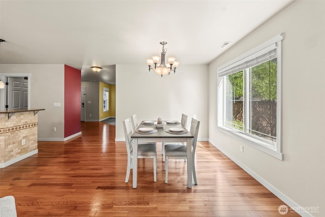 4492 Fantail Pl SW, Port Orchard, WA 98367 - dining room with a chandelier, wood finished floors, and baseboards