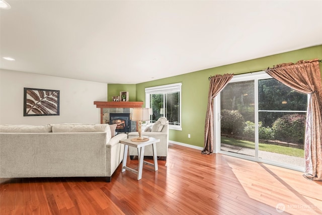 4492 Fantail Pl SW, Port Orchard, WA 98367 - living room with a tile fireplace, wood-type flooring, and baseboards