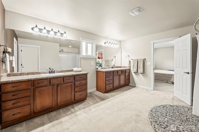4492 Fantail Pl SW, Port Orchard, WA 98367 - ensuite bathroom featuring two vanities, a stall shower, and baseboards