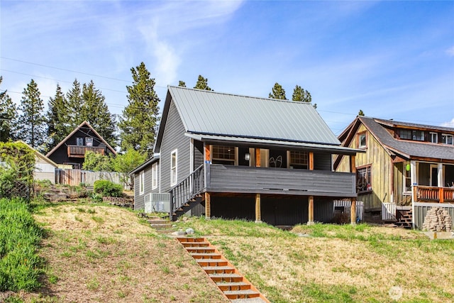 123 5th St, Roslyn, WA 98941 - rear view of property with stairway, metal roof, covered porch, and a lawn