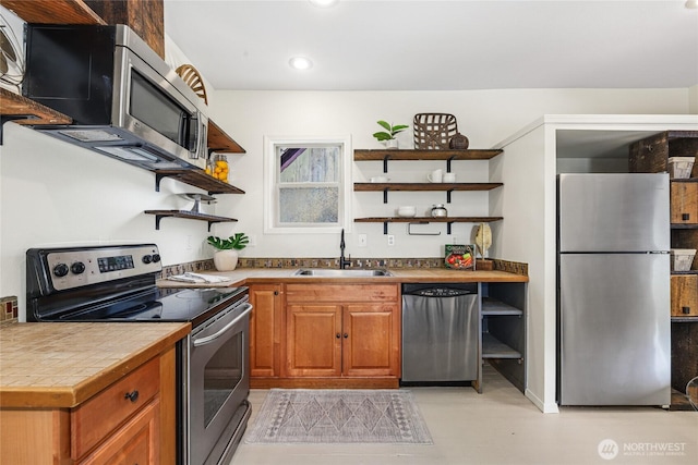 123 5th St, Roslyn, WA 98941 - kitchen featuring appliances with stainless steel finishes, open shelves, a sink, recessed lighting, and brown cabinetry