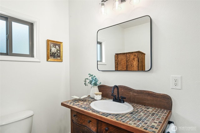 123 5th St, Roslyn, WA 98941 - half bathroom featuring vanity, toilet, and plenty of natural light